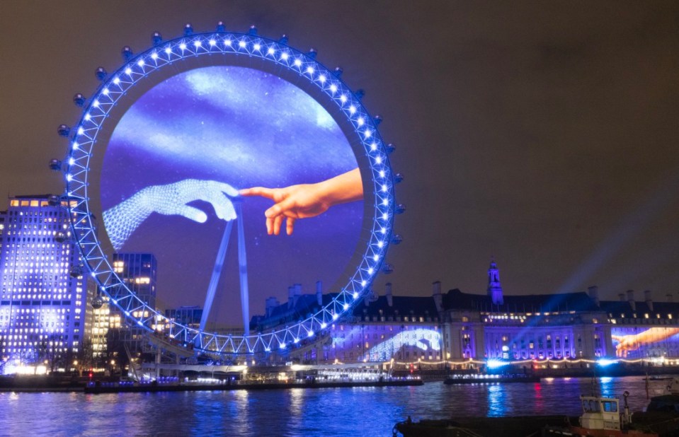 EDITORIAL USE ONLY An AI version of 'the hand of God' from Michelangelos Creation Of Adam is projected on the lastminute.com London Eye as part of a light display on London's Southbank to mark the launch of Samsung Galaxy S25 series. Issue date: Thursday January 23, 2025. PA Photo. The spectacle, combining projection mapping and hologauze technologies for the very first time marks a new chapter in Galaxy AI technology, introducing the next evolution of mobile AI experiences. Photo credit should read: Matt Alexander/ PA Media Assignments